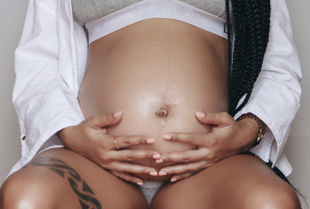 pregnant woman holding her belly preparing for birth