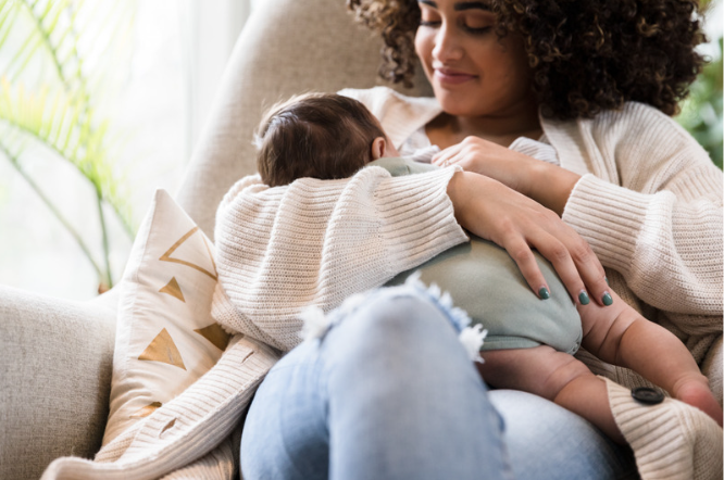 mom holding her newborn in her 4th trimester wondering how to start healing her body from birth and reconnecting with her partner