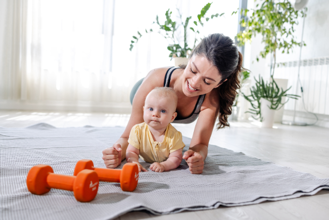 postpartum woman exercises with her baby under the guidance of postpartum fitness specialist beth colucci foppiano 