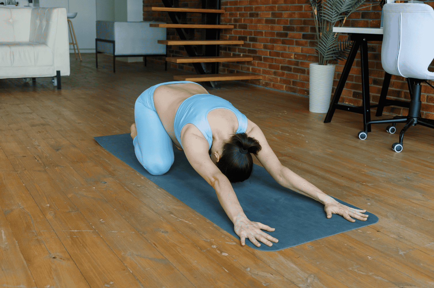 pregnant woman practices child's pose to help release her pelvic floor