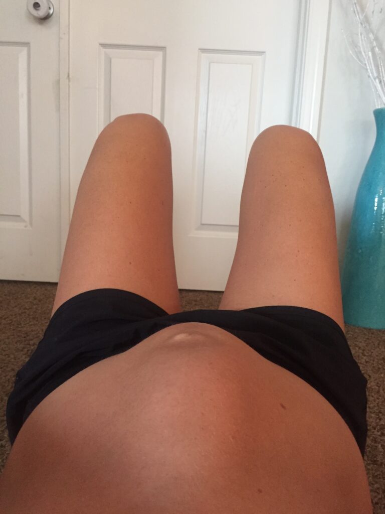 pregnant mom shows doming or bulging in her abdomen when doing a prenatal core workout